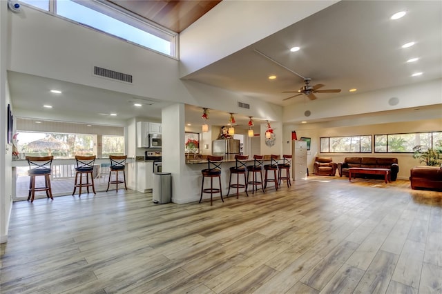 living room with a wealth of natural light and light wood-type flooring