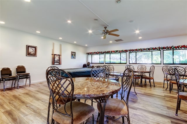 dining area featuring ceiling fan, a wealth of natural light, and light hardwood / wood-style flooring