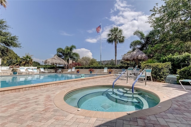 view of pool with a community hot tub and a patio