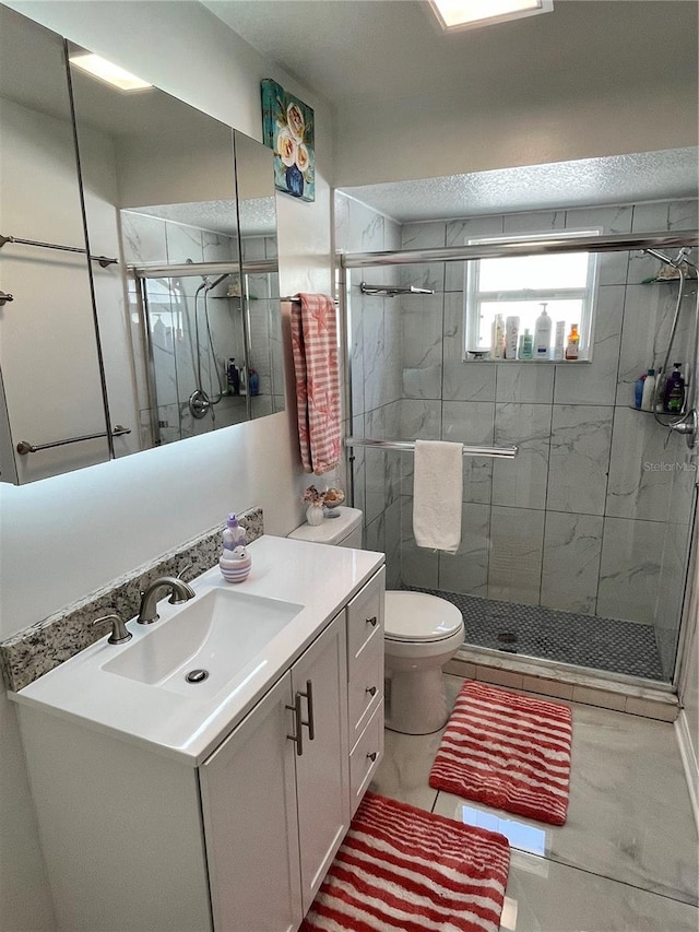 bathroom with a shower stall and vanity
