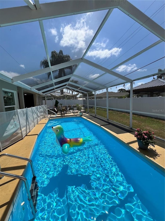 view of swimming pool featuring a lanai, a fenced in pool, a fenced backyard, and a patio area