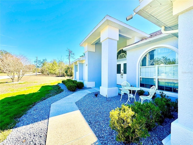 view of side of home featuring a yard and french doors