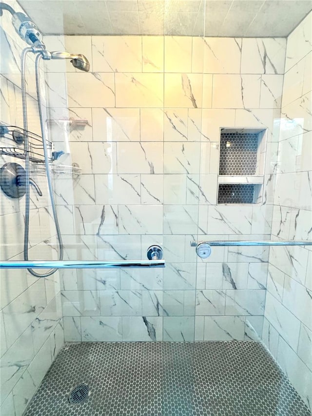 bathroom with tiled shower