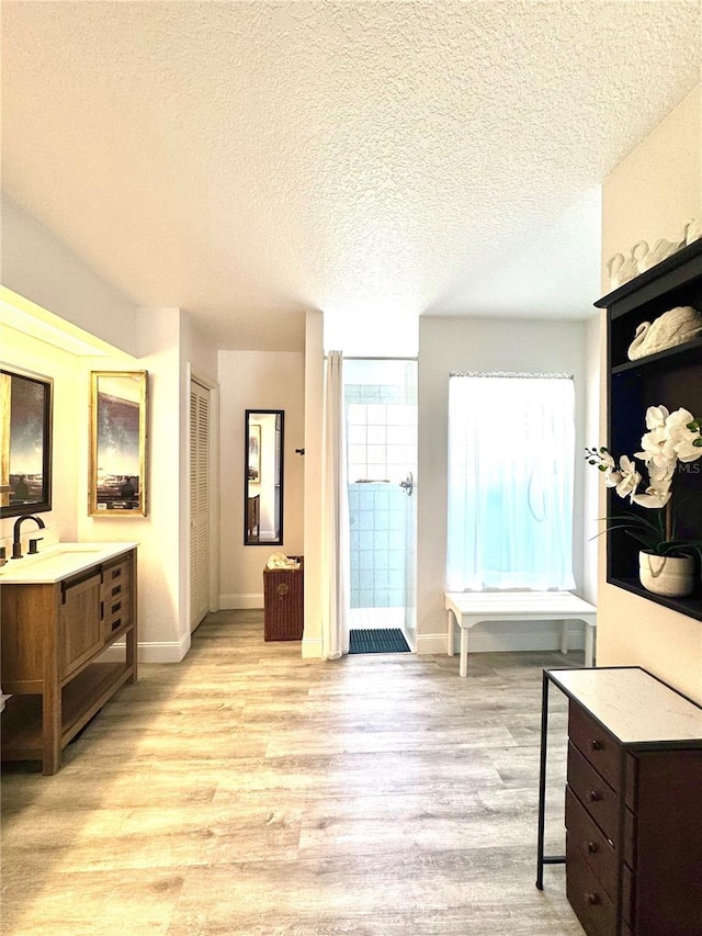 bathroom featuring vanity, hardwood / wood-style floors, and a textured ceiling