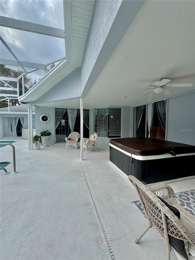 view of swimming pool with a hot tub, a patio, a lanai, and ceiling fan