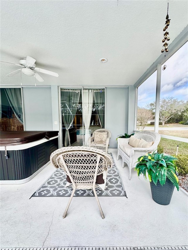 sunroom featuring ceiling fan