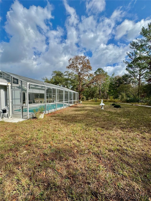 view of yard with glass enclosure