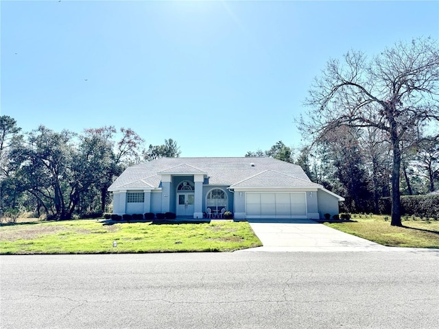 single story home featuring a garage and a front yard