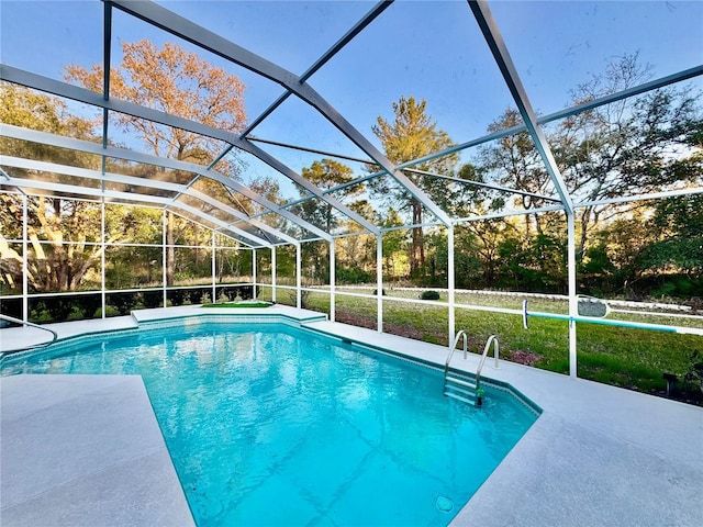 outdoor pool featuring a lanai and a patio area