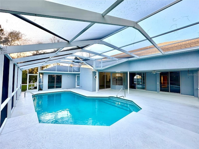 pool featuring a lanai, a patio area, and ceiling fan