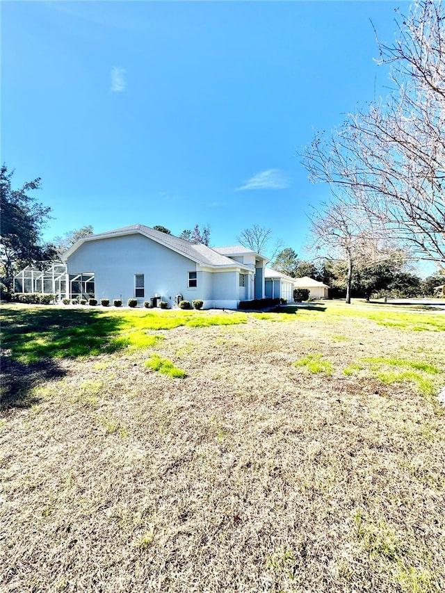 view of side of home featuring a lawn