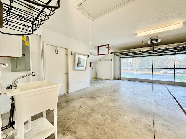 garage featuring a garage door opener and a sink