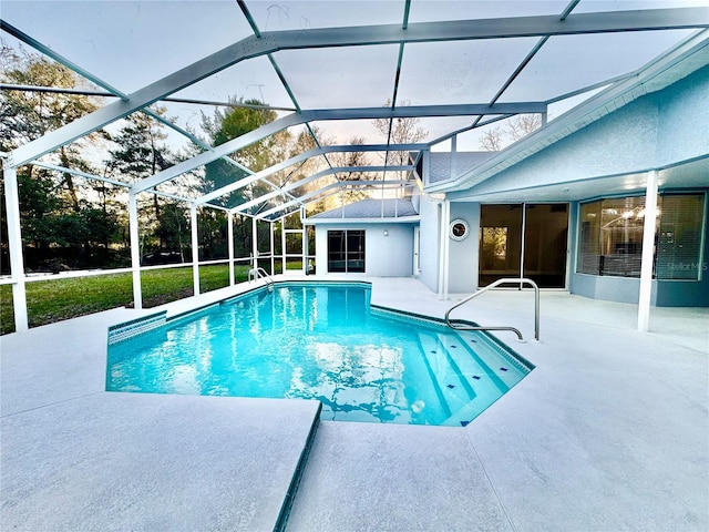 pool featuring glass enclosure and a patio