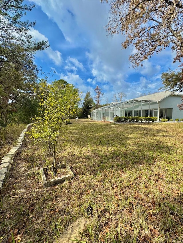 view of yard featuring a lanai