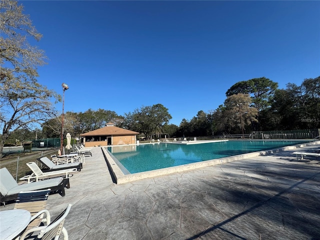 pool featuring a patio area and fence