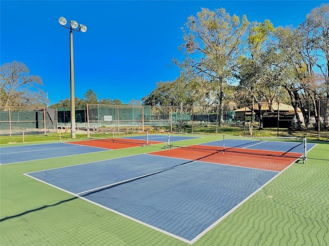 view of sport court featuring community basketball court and fence