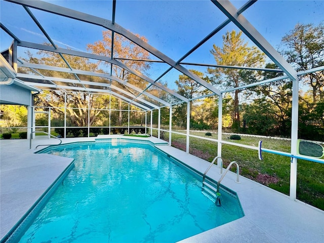 outdoor pool with glass enclosure and a patio area