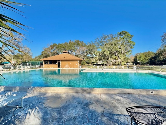 pool featuring a patio and fence