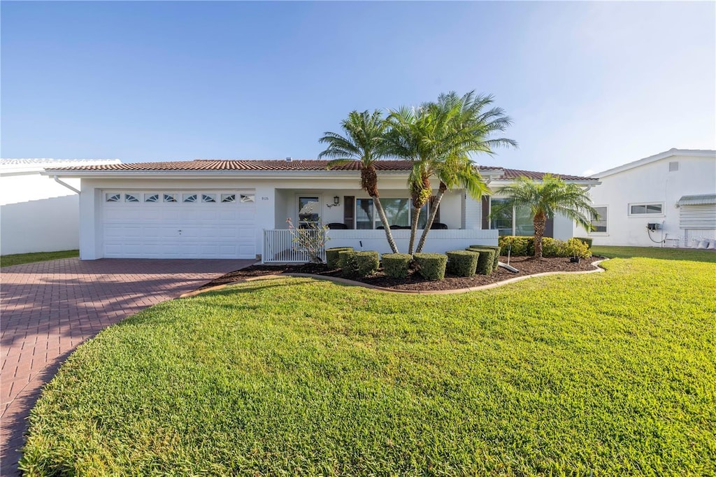 single story home with a front yard and a garage