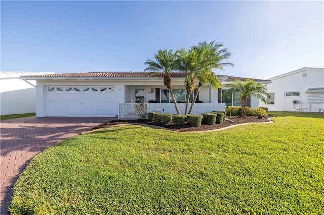 single story home with a front yard and a garage