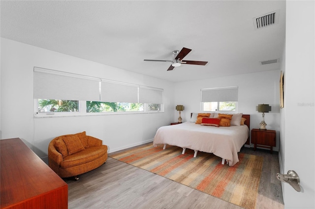 bedroom with ceiling fan and hardwood / wood-style floors