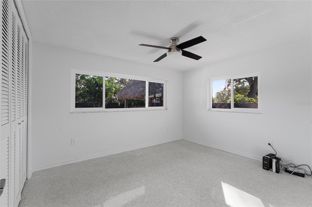 unfurnished bedroom with ceiling fan, a closet, and a textured ceiling