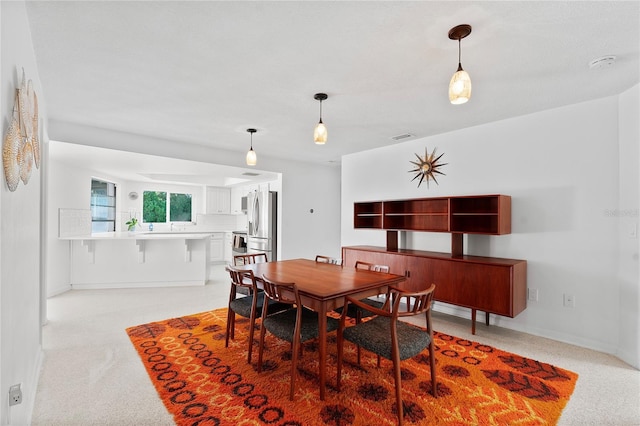 dining area with light colored carpet