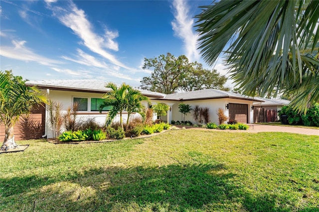 view of front of property featuring a garage and a front lawn