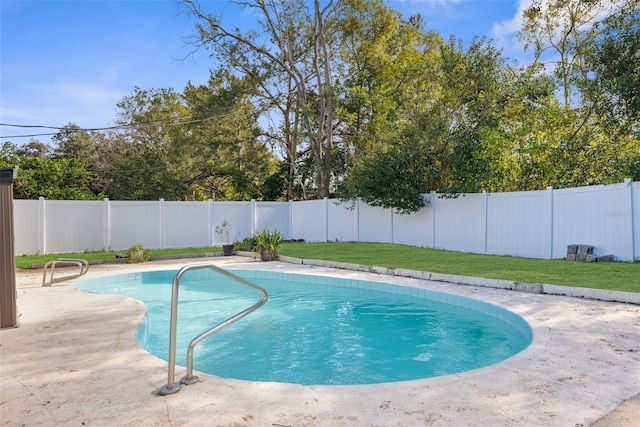 view of swimming pool featuring a yard and a patio area