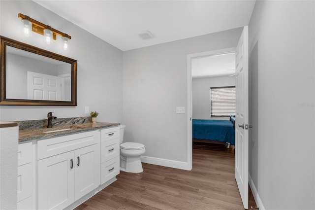 bathroom featuring hardwood / wood-style floors, vanity, and toilet