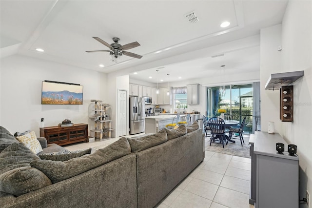 living room with ceiling fan and light tile patterned floors