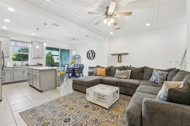 tiled living room with sink and ceiling fan