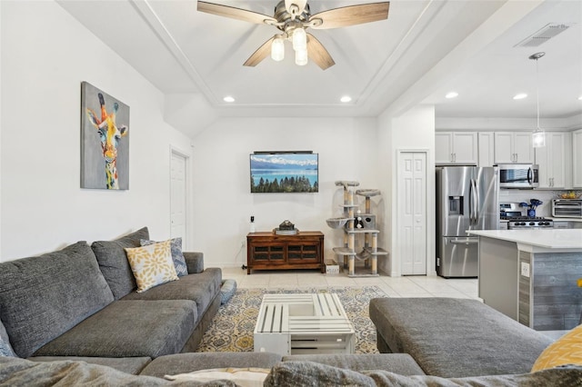 tiled living room with ceiling fan