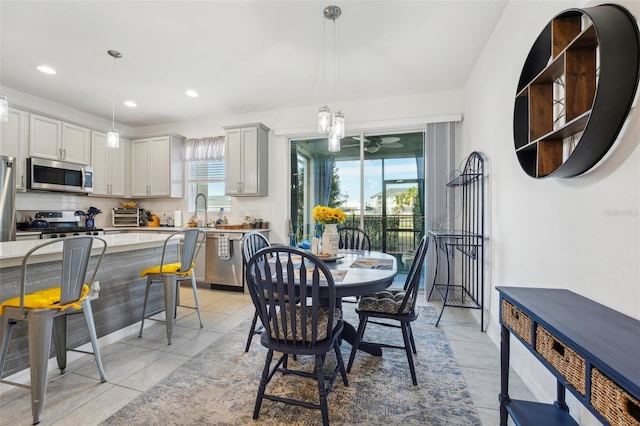 tiled dining area featuring sink and a wealth of natural light