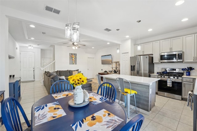 dining room with light tile patterned floors and ceiling fan