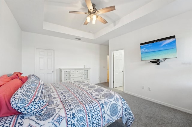 bedroom featuring carpet flooring, ceiling fan, and a tray ceiling