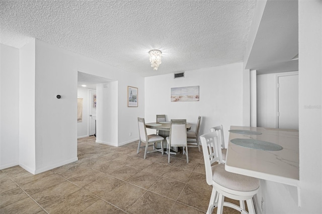 dining room featuring a textured ceiling