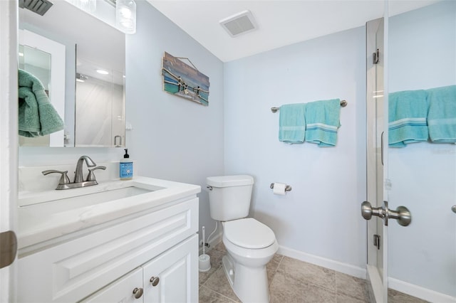 bathroom with vanity, toilet, and walk in shower