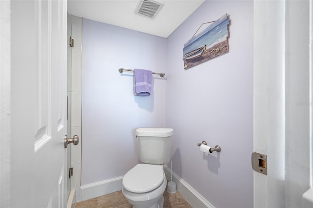 bathroom with tile patterned flooring and toilet