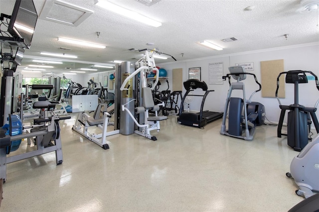 workout area with ornamental molding and a textured ceiling