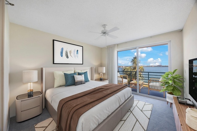 bedroom with ceiling fan, light colored carpet, a textured ceiling, and access to outside