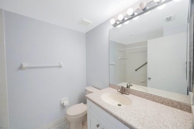 bathroom featuring walk in shower, tile patterned floors, vanity, and toilet