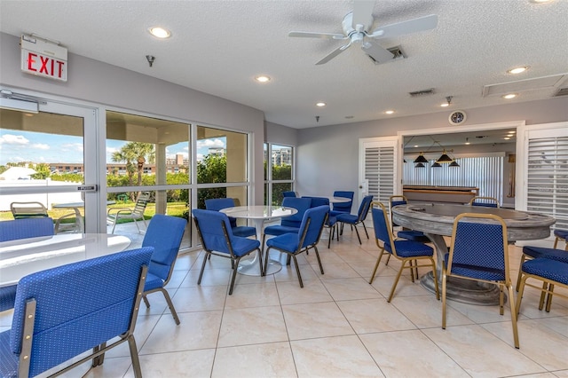 dining area with light tile patterned floors, a textured ceiling, and ceiling fan