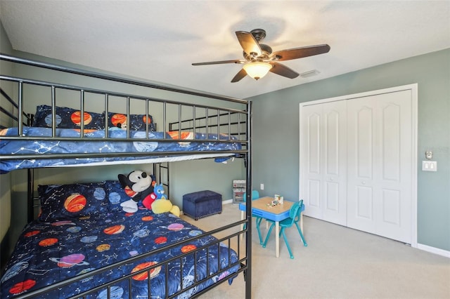 carpeted bedroom featuring a closet and ceiling fan