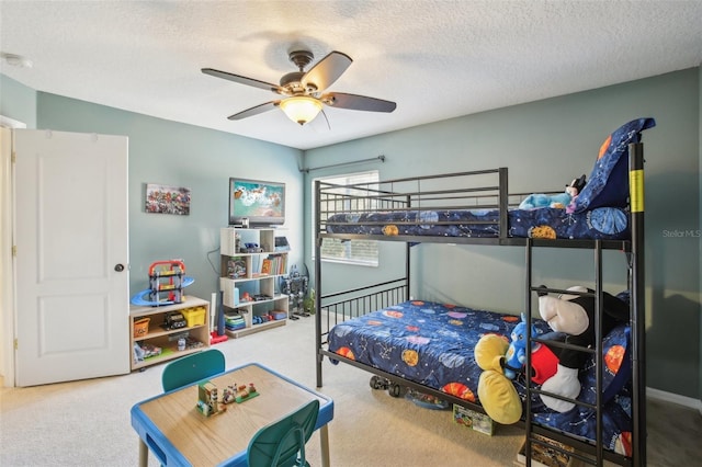 carpeted bedroom featuring a textured ceiling and ceiling fan