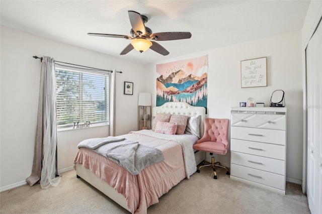 bedroom featuring light carpet, a closet, and ceiling fan