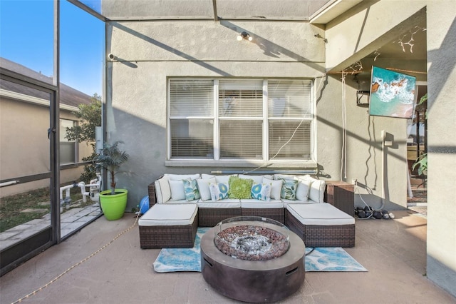 view of patio / terrace with an outdoor living space with a fire pit