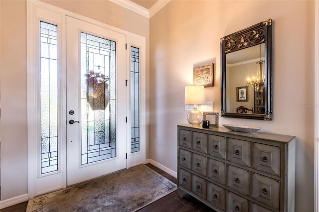 entrance foyer featuring dark wood-style floors, ornamental molding, baseboards, and a healthy amount of sunlight