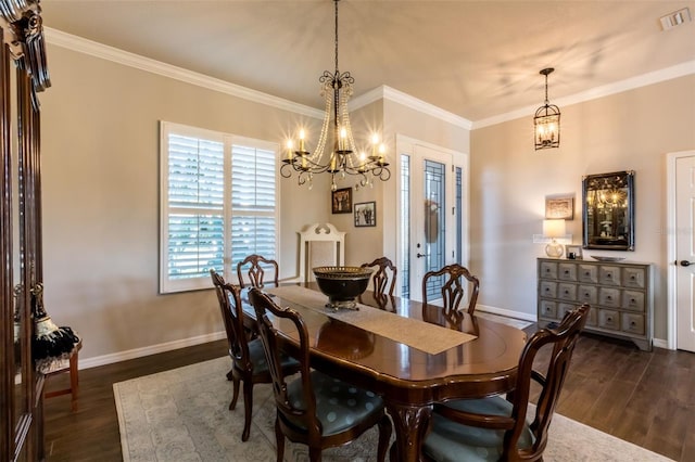 dining area with a chandelier, ornamental molding, dark wood-style flooring, and visible vents