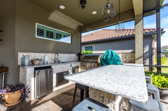 view of patio featuring grilling area, a sink, and area for grilling